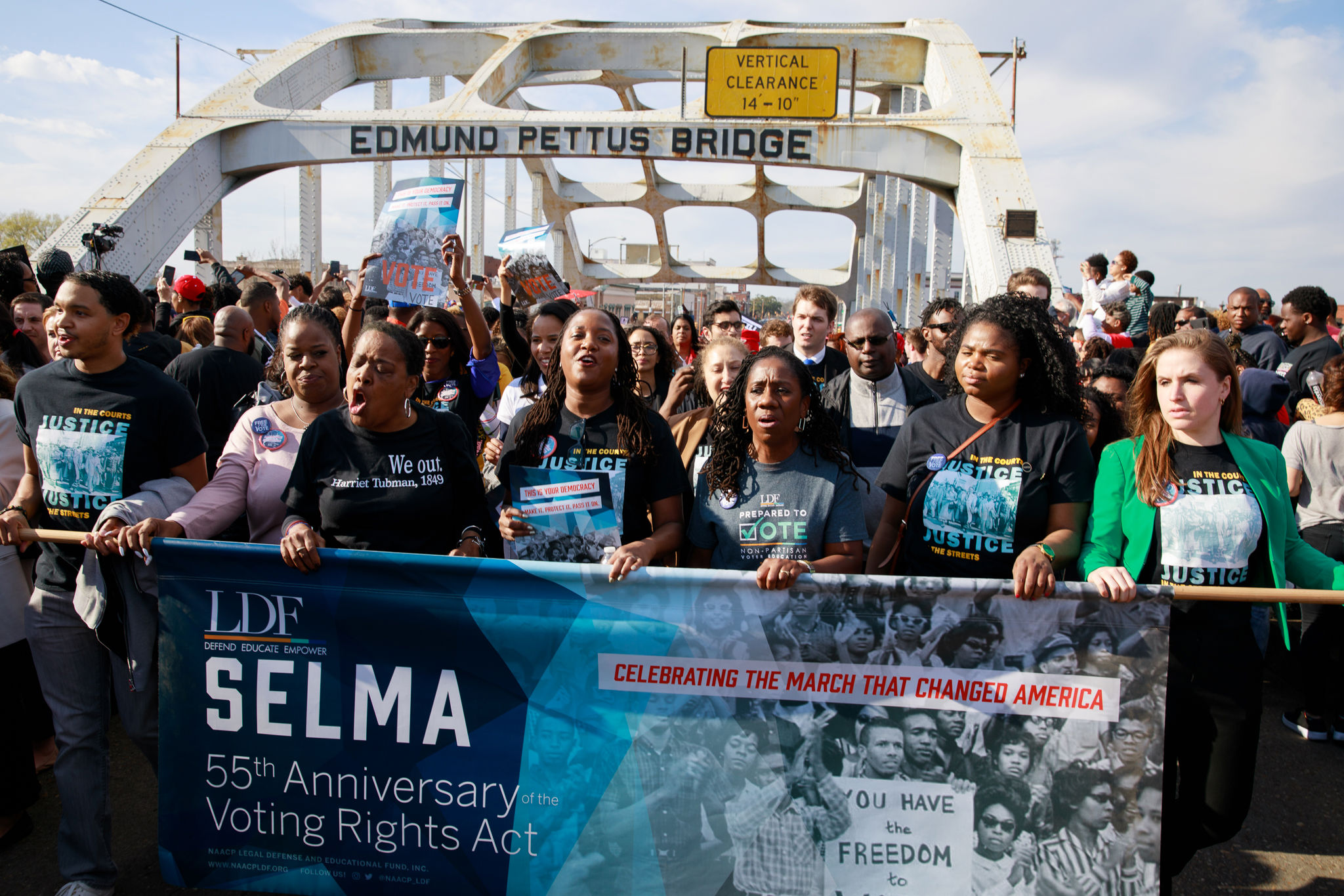 Marchers on Edmund Pettus bridge, commemorating the 55th Anniversary of the Voting Rights Act with a banner
