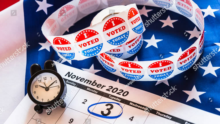 Calendar with November 3rd circled, resting on a flag background with "I Voted Today" stickers