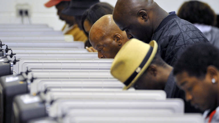 People standing over voting booths 