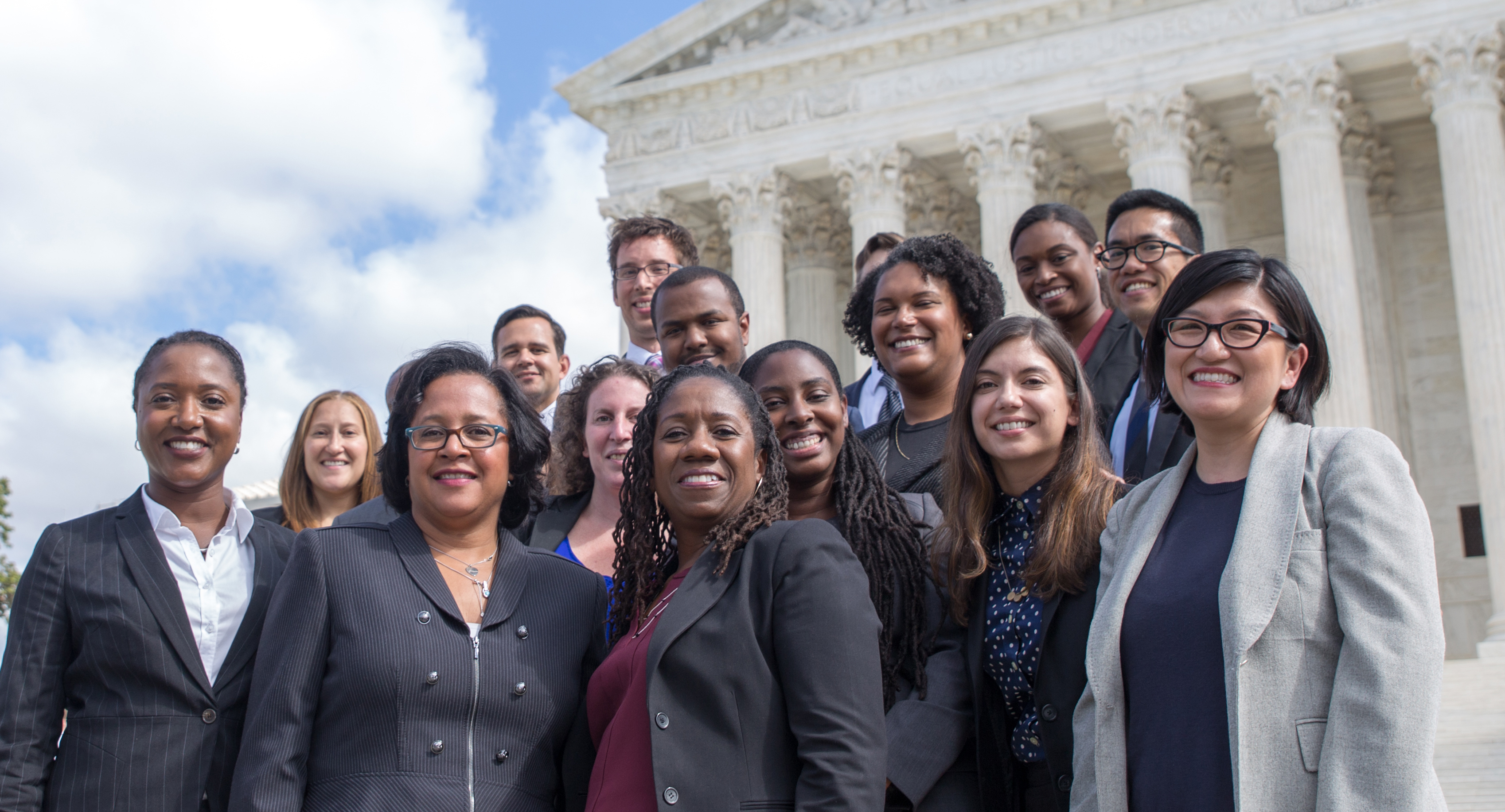Group of people in suits in front of the Supreme Court of the United States
