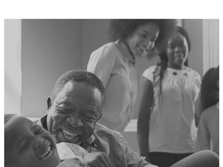 Brochure cover for "Black People and the Census" featuring an image of a man and his young granddaughter laughing while other family members look on