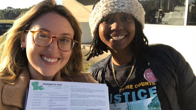 Smiling volunteers holding paperwork