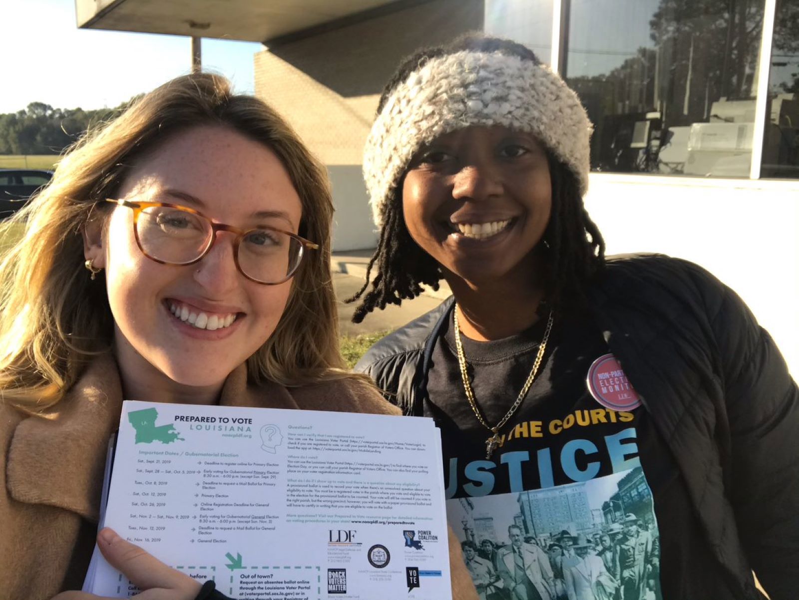 Smiling volunteers holding paperwork