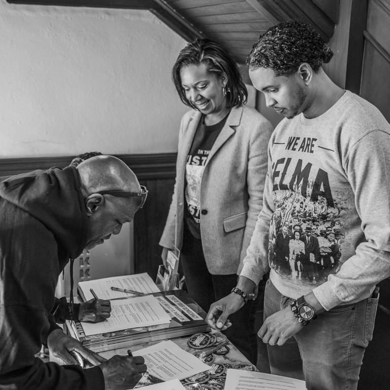 Man receiving voting information from volunteers